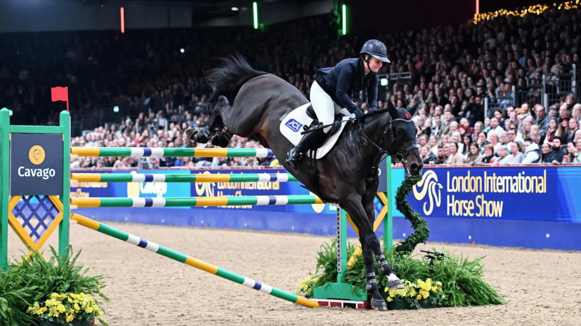 Gemma Stevens winning the Cavago Six Bar at London International Horse Show.